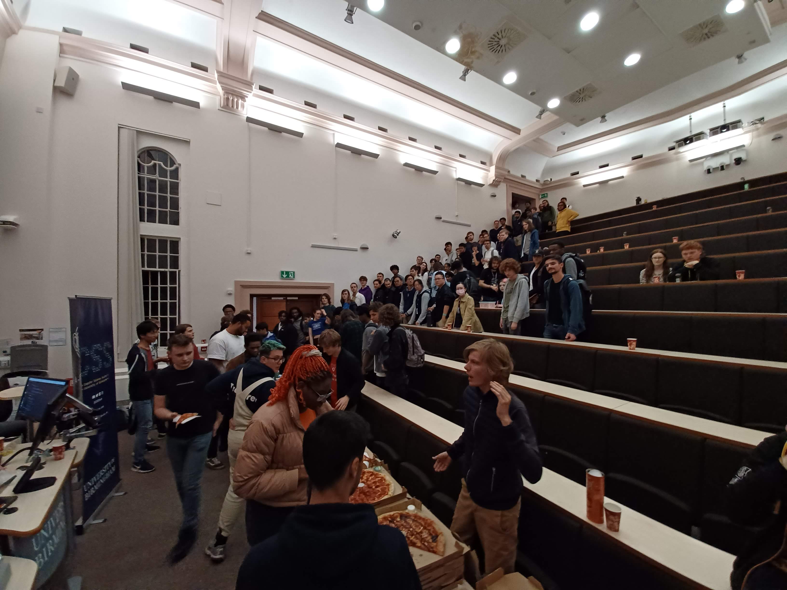 A photo from the CS Societies Night, with everyone lining up to get pizza.